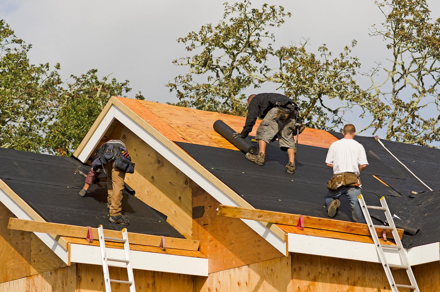 roofers repairing roof wind damage
