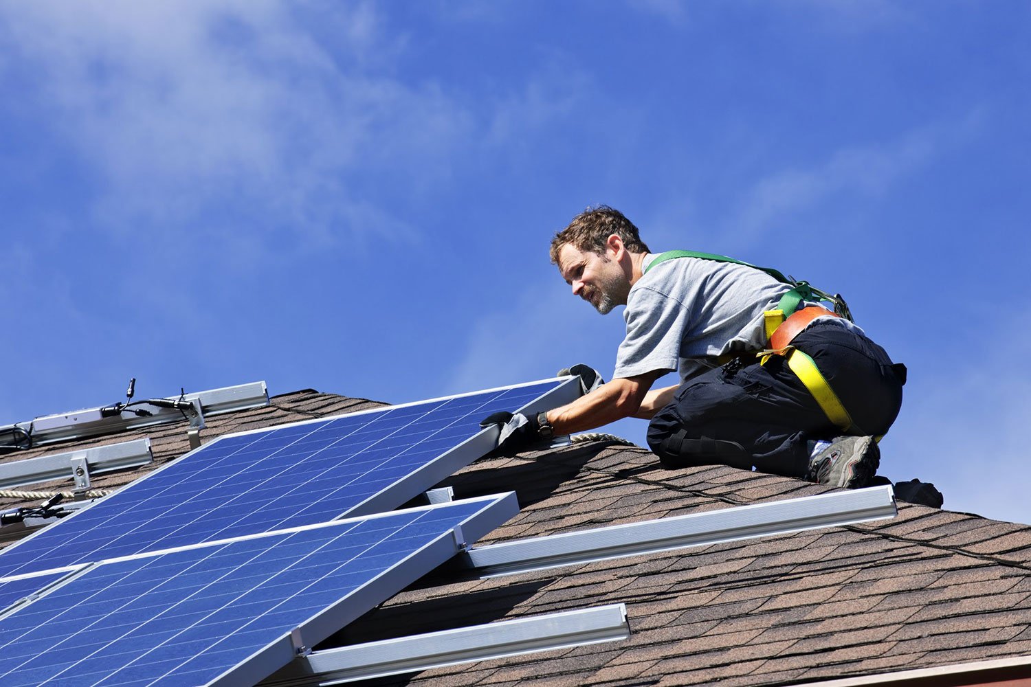 professional roofer installing solar panels