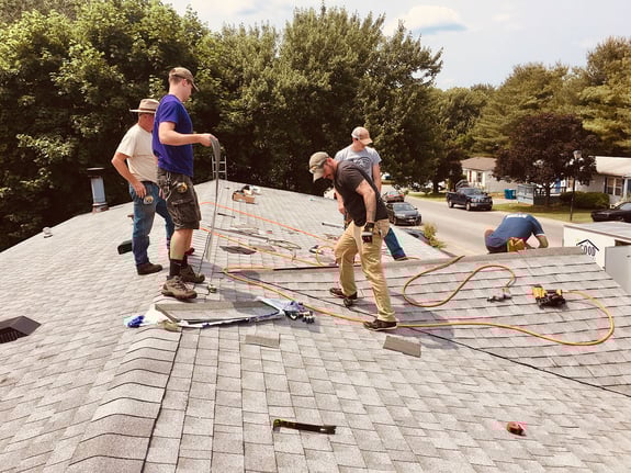 roofing contractors working on asphalt shingles