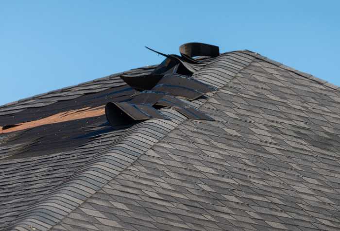 wind blowing shingles off roof